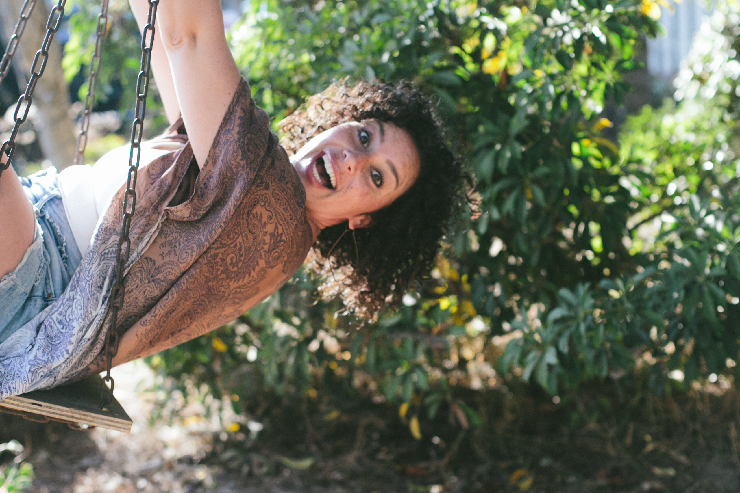 Elizabeth swinging with big smile on her face